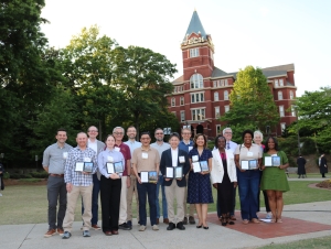 2026 Spring Sciences Honorees Faculty and staff honorees hold their awards during a group photo in front of Tech Tower