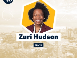 Headshot of Zuri Hudson with a faded background showing Georgia Tech's campus