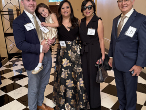A family group standing in a hallway